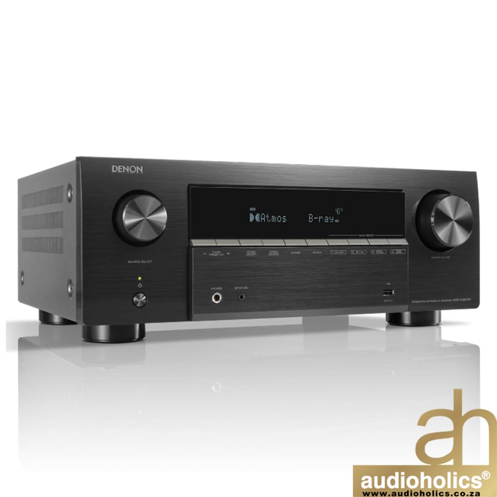 Denon AV receiver with brushed metal front, two large knobs, and a central display on a glossy surface.