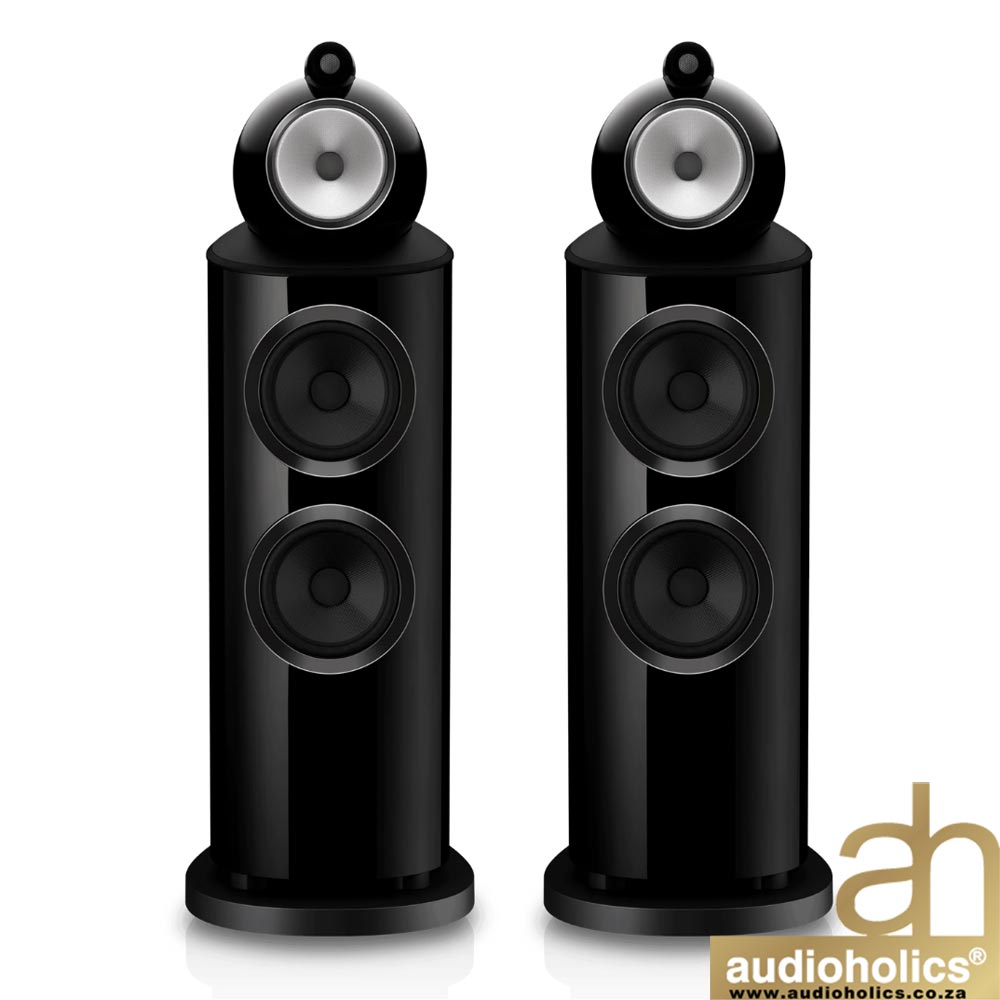 Pair of glossy black floor-standing speakers shown from the front, each with multiple drivers; Audioholics logo in bottom-right corner.