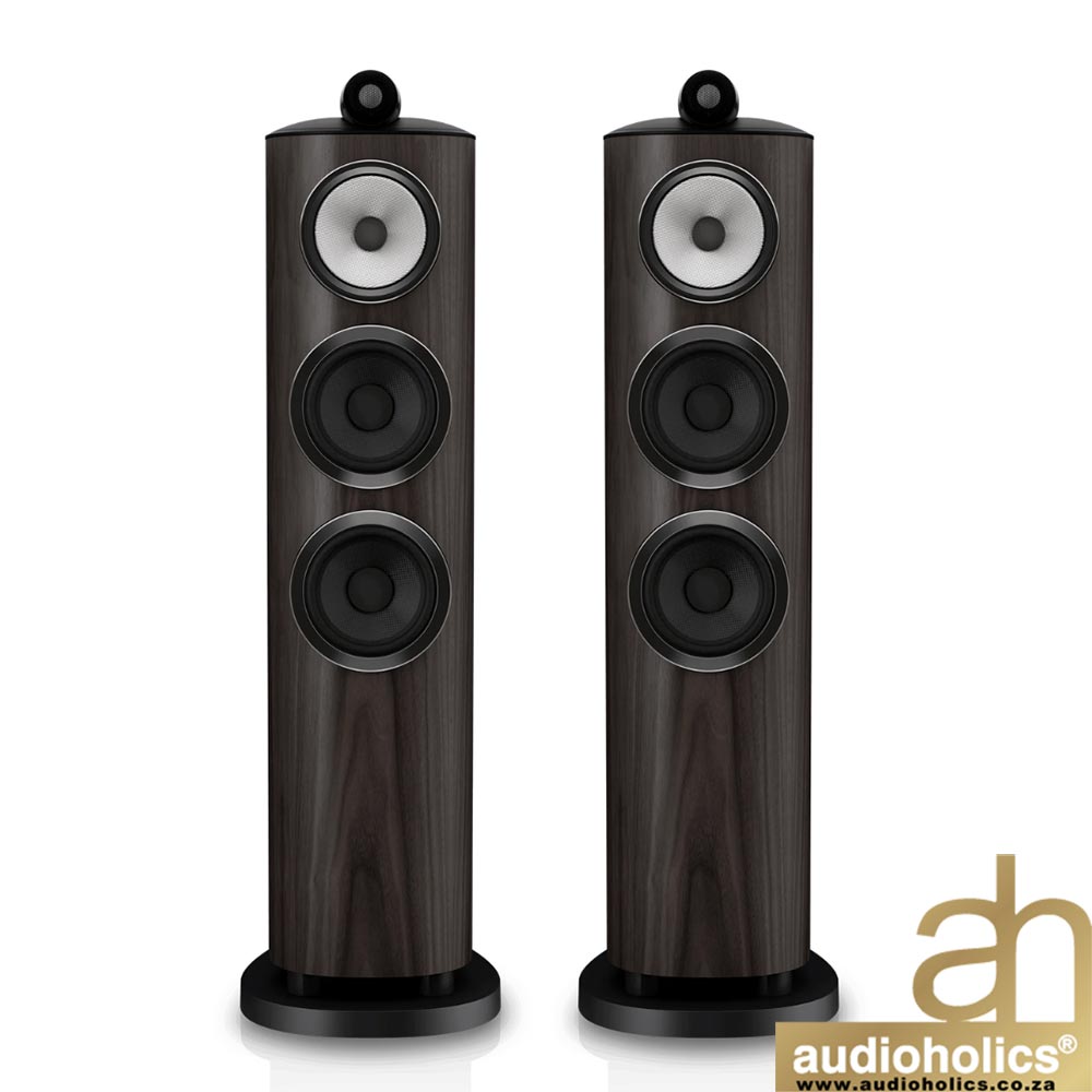 Pair of dark wood floor-standing speakers with three drivers each, front view; audioholics watermark bottom right.
