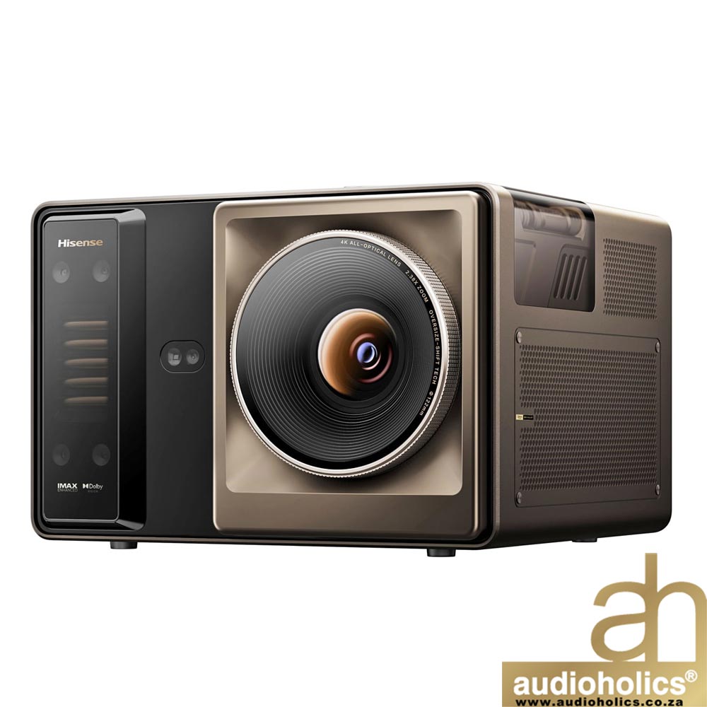 Large beige projector with a prominent circular lens, brand details on the left, and Audioholics logo in the bottom-right corner (4K projector).
