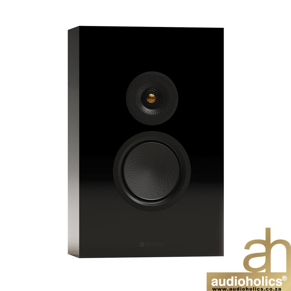 Black glossy bookshelf speaker with a large woofer and a smaller tweeter, Audioholics watermark bottom right
