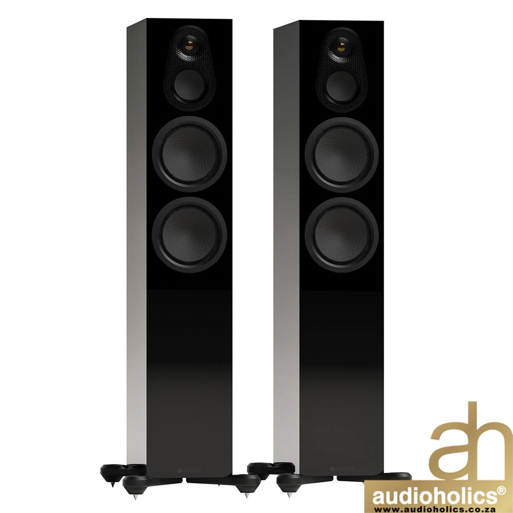 Pair of black floorstanding speakers with silver side panels and multiple drivers, positioned side by side, Audioholics logo bottom right.