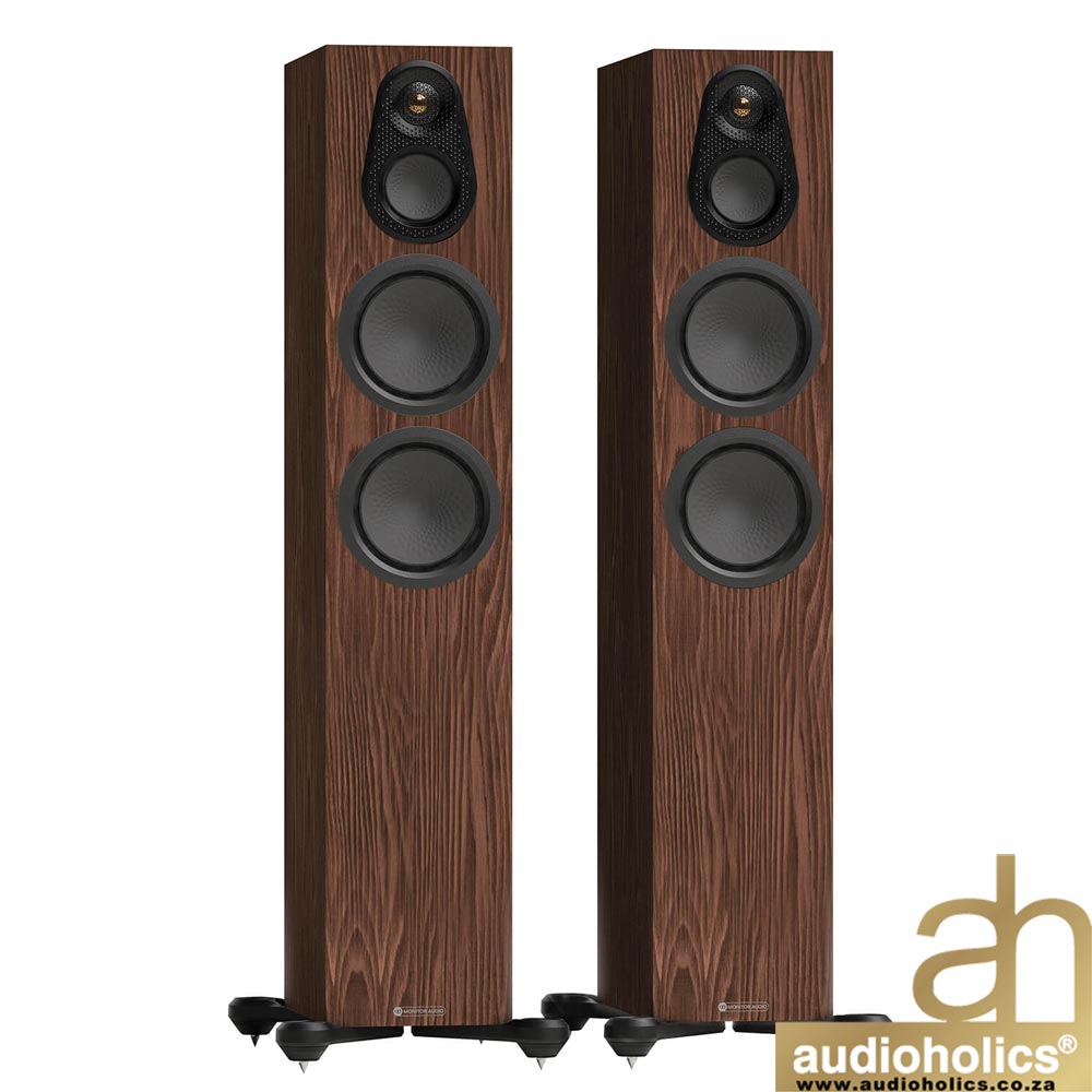 Monitor-Audio-Silver-300-Walnut - Audioholics South Africa Pair of walnut-finish floor-standing speakers with a small tweeter above two larger drivers; Audioholics logo in the corner.