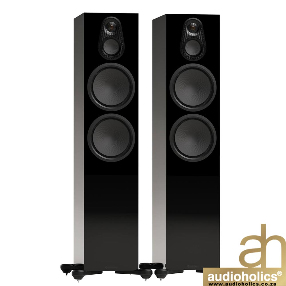 Pair of tall black floor-standing speakers with glossy fronts and silver sides, Audioholics logo bottom right