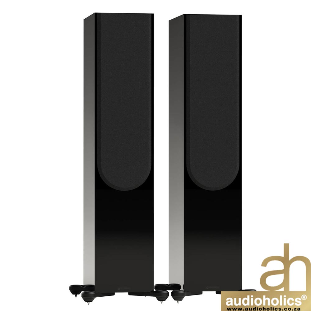 Monitor-Audio-Silver-500-Blackjpg-3 - Audioholics South Africa Pair of tall black floor-standing speakers with curved front grills, shown from the front; Audioholics logo in the bottom-right corner.
