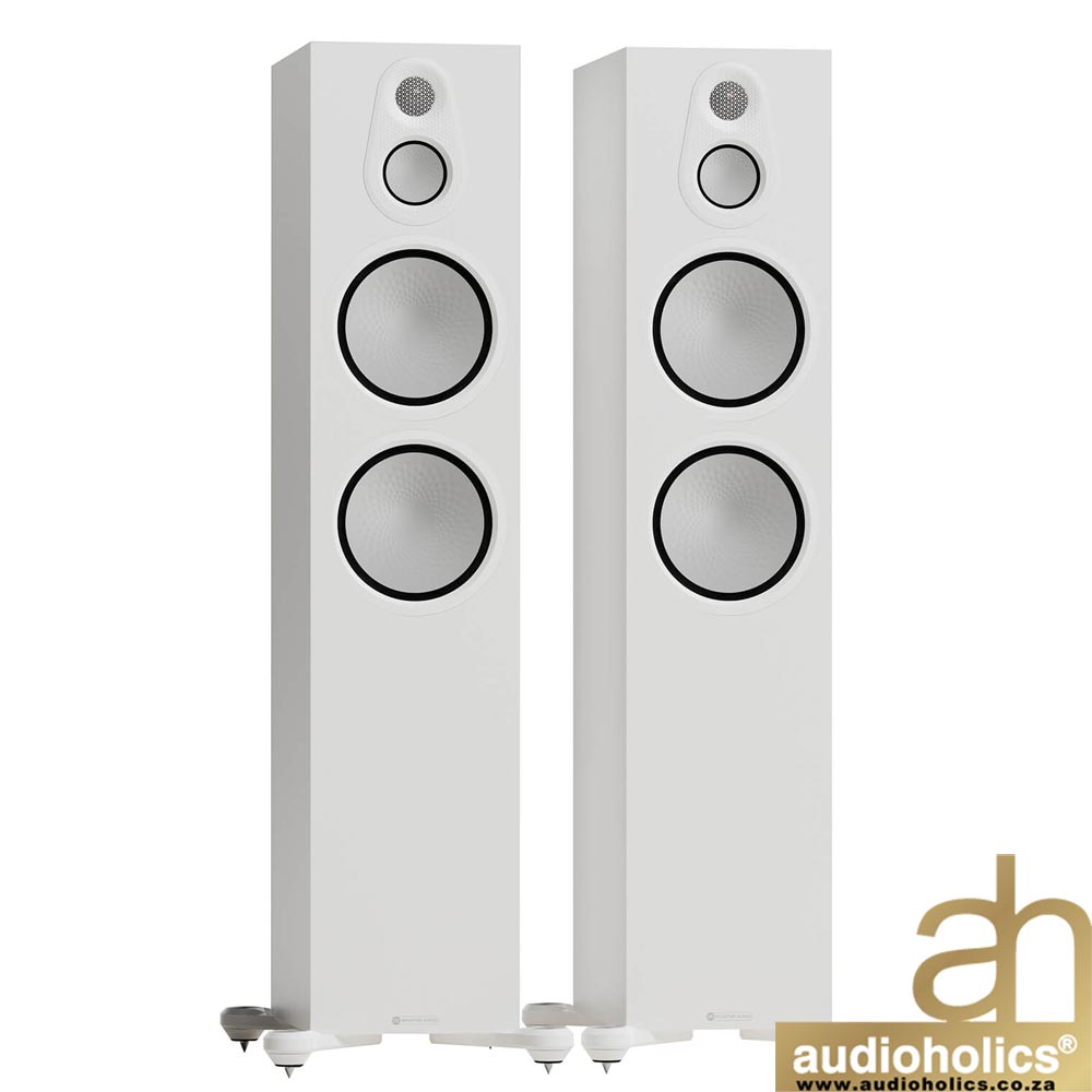 Monitor-Audio-Silver-500-White - Audioholics South Africa Pair of tall white floor-standing speakers with two large circular drivers and a smaller top tweeter, mounted on white bases; Audioholics logo in the bottom-right corner.