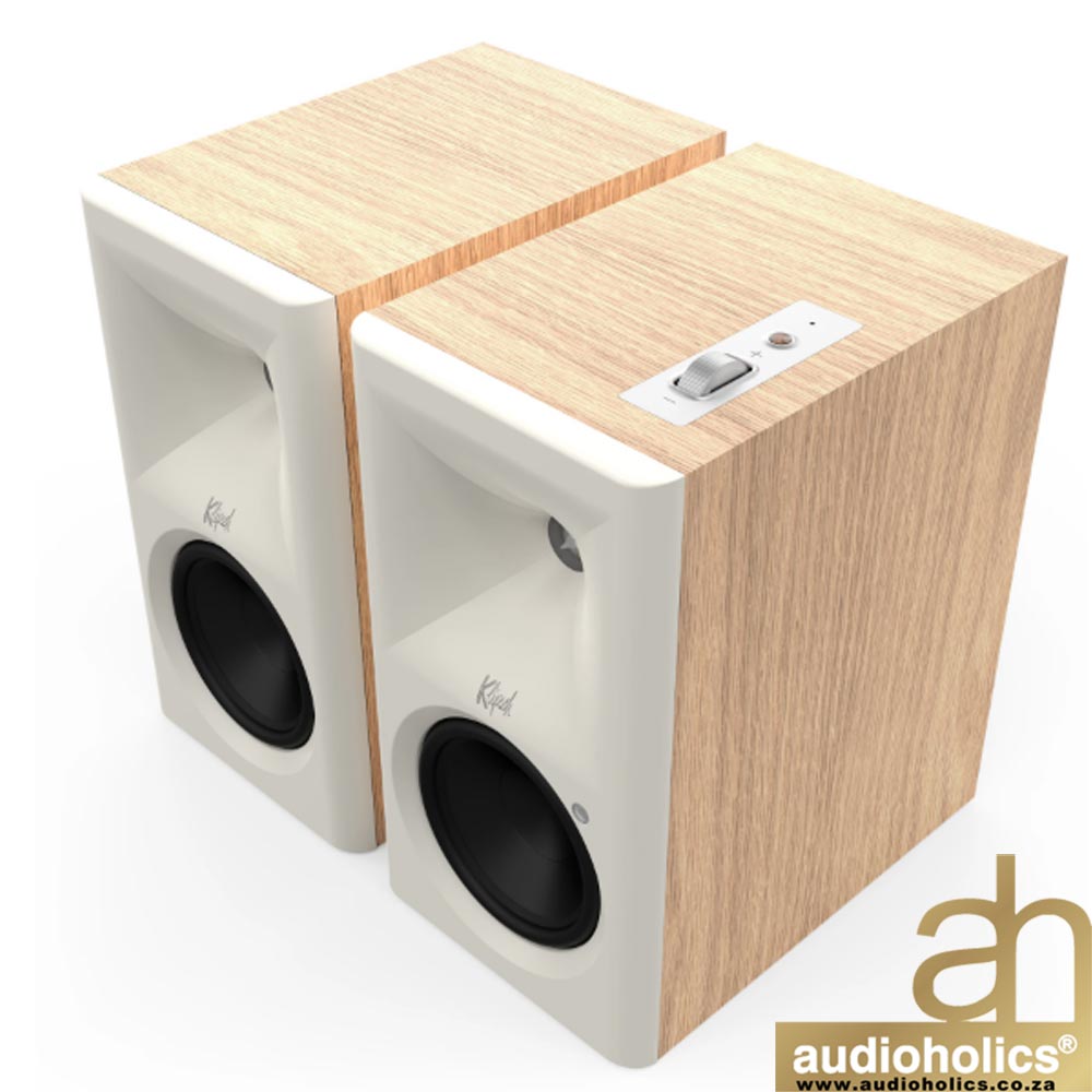 Klipsch-The-Fives-II-Main---Red-Oakjpg-1 - Audioholics South Africa Pair of light wood–finished bookshelf speakers with white front panels and black drivers, shown from a corner view.