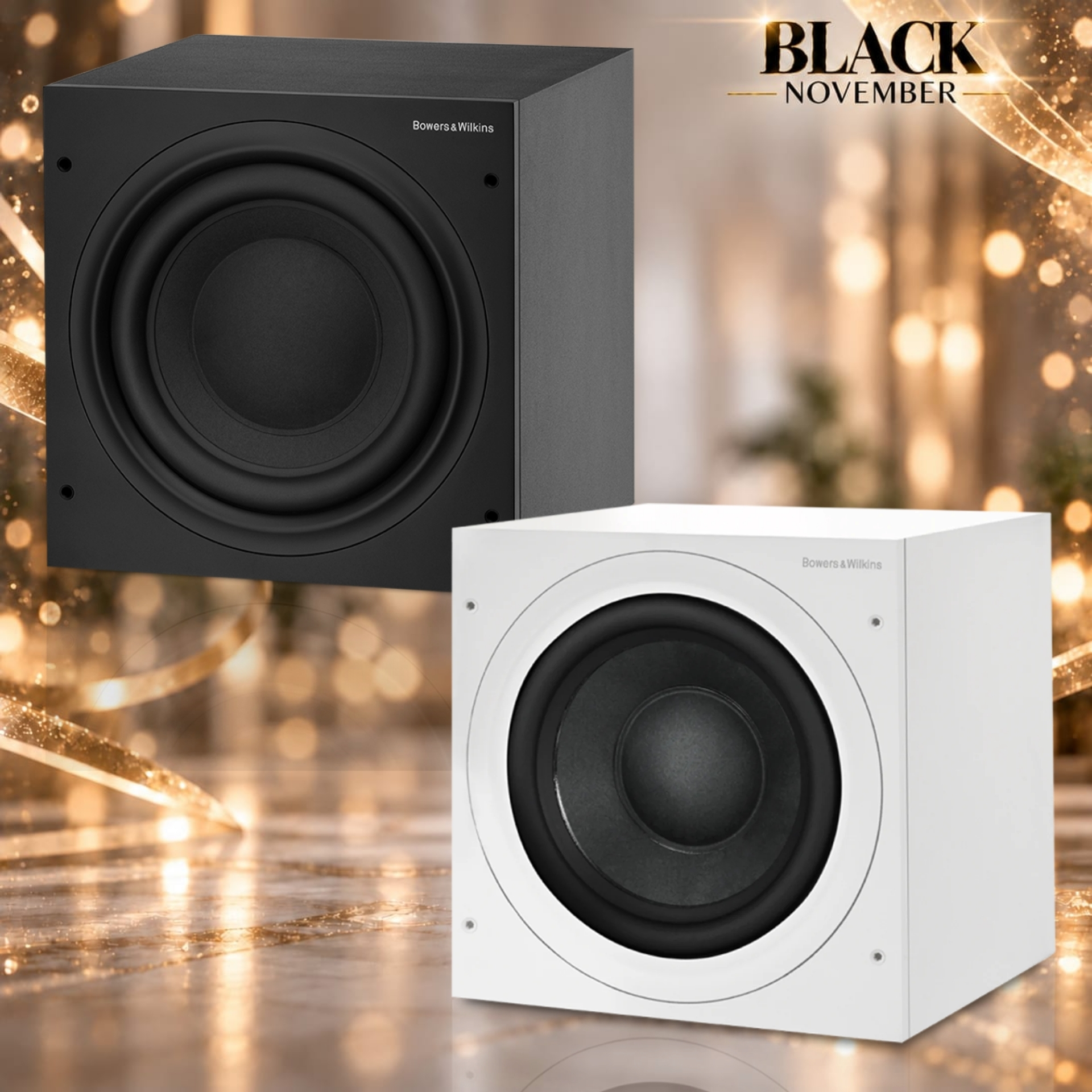 610 - Audioholics South Africa Pair of Bowers & Wilkins speakers (black and white) on a glossy surface with a festive, gold background and 'Black November' banner behind them.