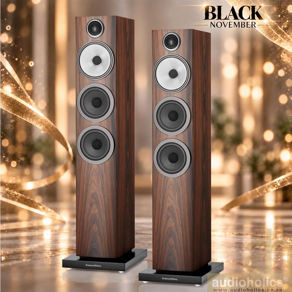 704-main - Audioholics South Africa Two tall wooden floor speakers with multiple drivers stand side by side in a festive, golden background; promo text reads 'BLACK NOVEMBER' in the corner.